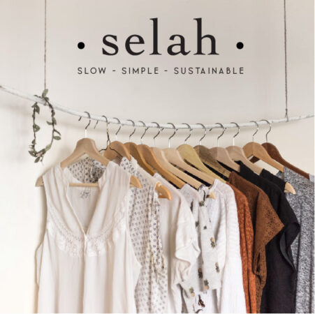 The new Selah logo is shown above a rack of their simple, slow and sustainable clothing.